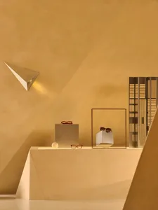 A modern retail storefront featuring metallic rectangular shapes and planes.