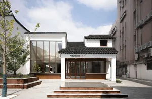 A modern coffee shop with a glass exterior and traditional roof.