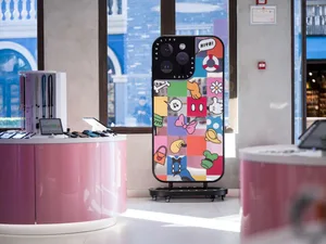 A large, glass display case showcasing various phone cases in a retail setting.