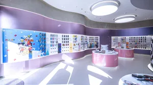 A retail storefront showcasing various Disney-themed merchandise on a purple wall.