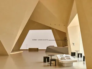 A minimalist retail store space with concrete walls and geometric shapes.