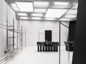A modern commercial space featuring marble and concrete shelves.