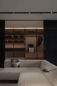 Modern interior design with neutral tones focusing on a closet area.