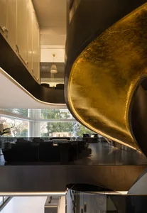 Modern living room with metallic gold accents and contemporary furnishings