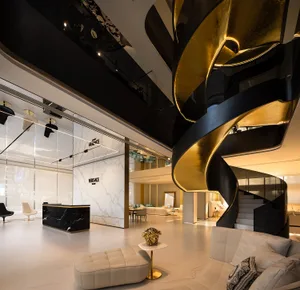 A modern lounge featuring marble, black, gold, and steel elements