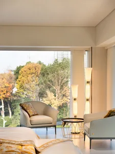 A minimalist living room featuring neutral-toned fabrics and elegant furniture.