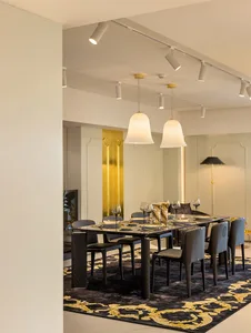 Modern dining room featuring black metal furniture and metallic gold accents.