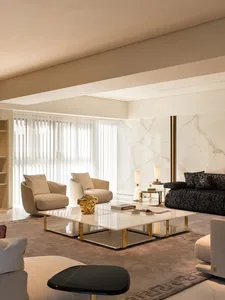 Modern living room featuring marble surfaces, glass elements, and contemporary furniture.