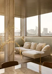 Modern living room with marble walls, concrete floor, and cloth furniture.