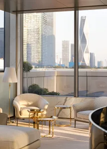 Modern living room featuring marble and golden metal furniture.