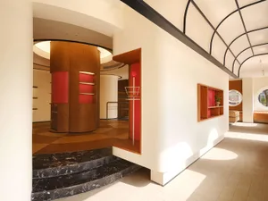 Modern retail storefront with a combination of wood and red materials.