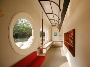 A modern interior space with white walls, clean lines, and sleek furniture.