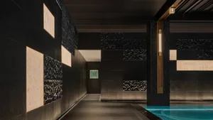 Modern interior design featuring a sleek concrete swimming pool with illuminated lighting fixtures.
