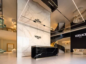 Modern Versace Home Office featuring marble walls and black marble desk