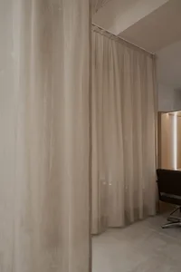 Fabric curtains in an interior design setting, providing privacy and aesthetic enhancement.