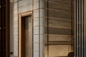 Modern commercial space featuring glass paneling and brass accents.