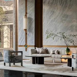 Modern living room with marble walls and leather furniture.