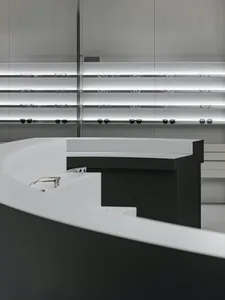 Modern retail space featuring metal shelves with glasses displayed