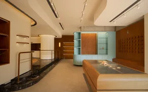 Interior of a modern retail shop featuring marble and wooden elements.