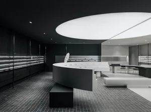 A modern, sleek retail shop interior with white porcelain surfaces and minimalist design.