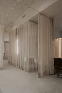 A serene spa interior with neutral-colored curtains and a minimalist design.