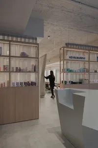 Modern spa interior with wooden shelves and products.
