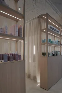Modern retail display features keratin hair products arranged on wooden shelves and cabinets with soft lighting and a soft cu