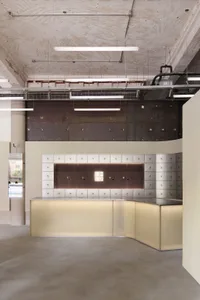 Modern office space featuring concrete walls and floors, minimalist design elements.