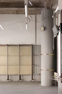 Industrial-style office space featuring concrete and metal materials.
