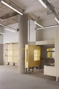 A modern office space with concrete columns and exposed roof beams.