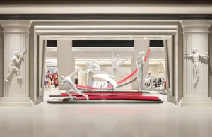 A retail display featuring statues in white, positioned to showcase a brand's sportswear.