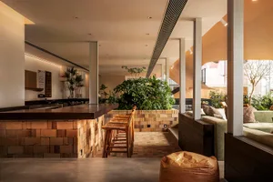 Interior design of a coffee shop featuring brick and concrete materials.