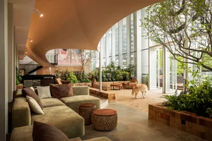 A modern lobby featuring concrete and glass materials.