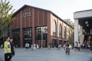 Outdoor view of Yi Wu Place shopping center showing brick, concrete, and glass architectural features.