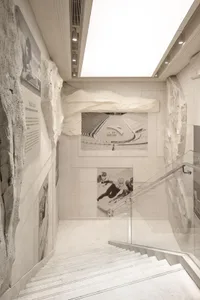 A modern minimalist sports exhibition space featuring sandstone elements.