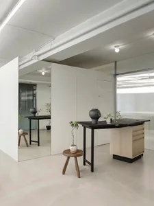Minimalist office space featuring wood and glass materials.