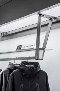 Modern interior design featuring a metal clothing display with an industrial look.