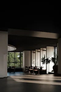 A minimalist cafe interior featuring a clay floor, calm lighting, and a relaxed atmosphere.