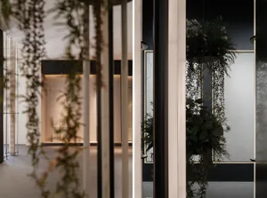 Photographic representation of a modern commercial interior space featuring potted plants.