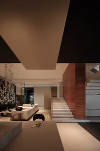 Contemporary residential interior with modern furniture, concrete and marble finishes.