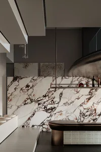 A modern interior with marble walls and ceiling, featuring a metallic counter and contemporary furniture.