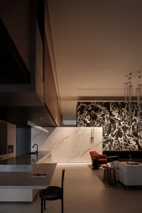 Modern kitchen featuring a marble backsplash and countertop.