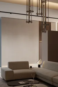 A modern living room featuring a beige textured couch with a sleek, metallic table lamp.