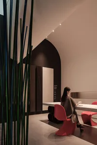 A modern restaurant with metallic decor and marble countertops.