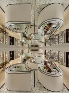 Modern bookstore interior with marble finishes and curved display units.