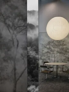 A modern cafe interior featuring paper lighting, concrete floor, and a paper print wall.