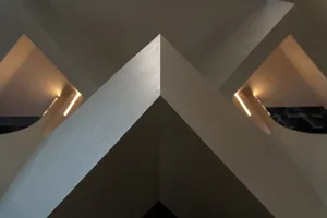 An interior design featuring modern concrete walls and geometric architectural elements.