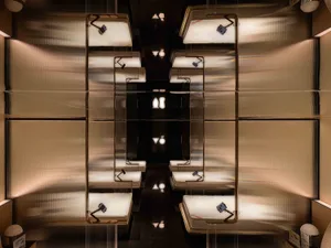 Modern hotel room with metallic steel furniture and beds.