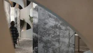 A modern interior with glass panels showcasing a landscape view.