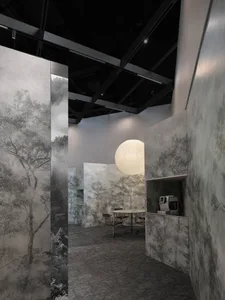 A modern office space featuring concrete walls and glass partitions